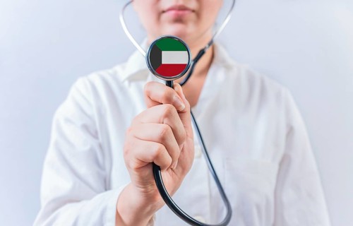 Female doctor holding stethoscope with Kuwait flag. National health system of Kuwait