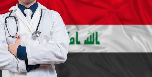 Male doctor with stethoscope on Iraq flag. Doctor holding stethoscope on Iraq flag