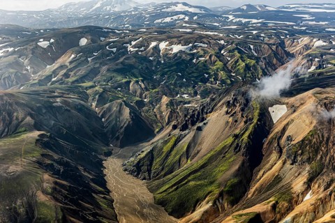 Mountain landscape, sunny, summer, river, snowfields, volcanic landscape, aerial view,