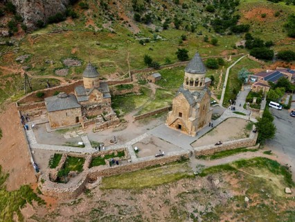 Close-up of an old stone church in a hilly landscape, aerial view, Noravank Monastery, Surb