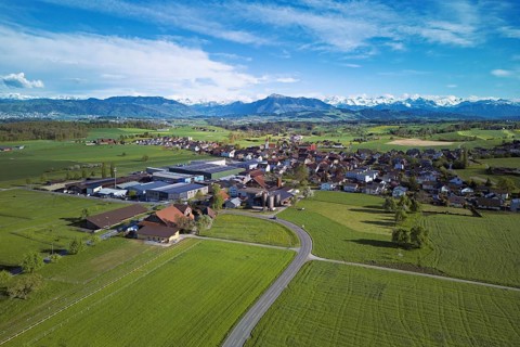 View of the village, in the foreground the industrial area, in the background the Rigi and the