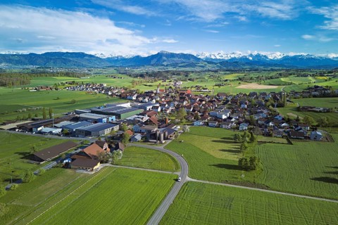 View of the village, in the foreground the industrial area, in the background the Rigi and the