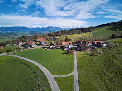 View of the hamlet of Brunnwil, behind the Rigi and the snow-covered Alps, Beinwil, Freiamt,