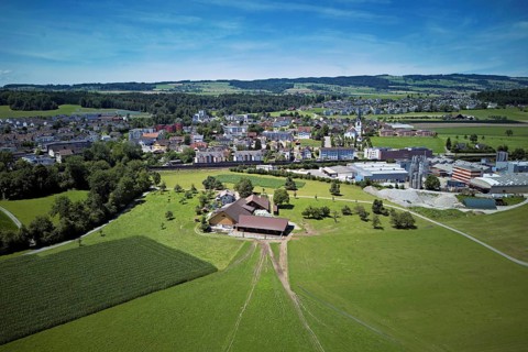View of the village with the catholic parish church Mariä Geburt, on the right the industrial area,