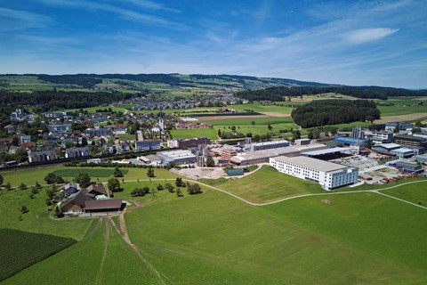 View of the village with the catholic parish church Mariä Geburt, on the right the industrial area,