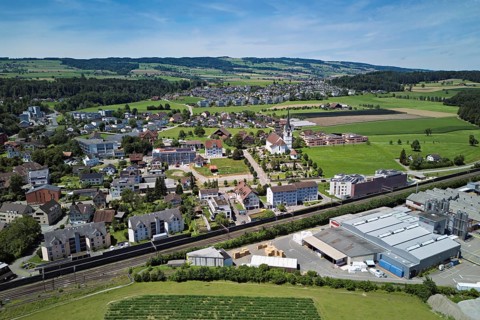 View of the village with the catholic parish church Mariä Geburt, on the right the industrial area,