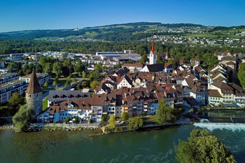 Old town with the Catholic Church of St Nicholas and the witches' tower, in the foreground the weir