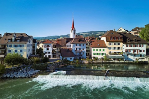 Old town with the Catholic Church of St Nicholas, in the foreground the weir on the river Reuss,