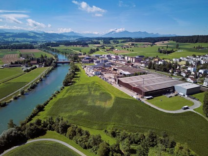 River Reuss, on the right the industrial area, behind the old wooden bridge and the Pilatus, Sins,