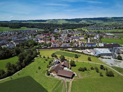 View of the village with the Catholic parish church Mariä Geburt, on the right the industrial area,