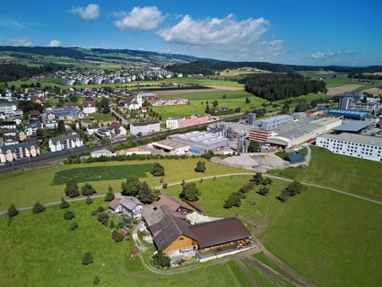 View of the village with the catholic parish church Mariä Geburt, on the right the industrial area,