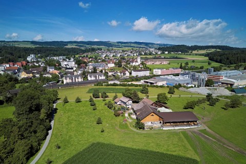 View of the village with the catholic parish church Mariä Geburt, on the right the industrial area,
