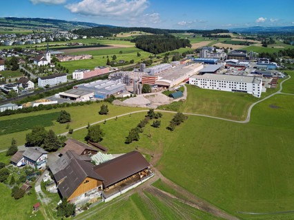 View of the village with the catholic parish church Mariä Geburt, on the right the industrial area,