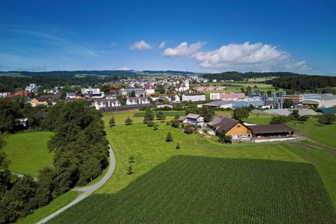 View of the village with the catholic parish church Mariä Geburt, on the right the industrial area,