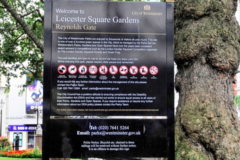 Information sign with park rules and prohibitions in Leicester Square Gardens, Westminster, London,