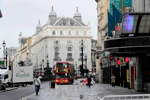 London, England, Great Britain, Europe, Red double-decker bus in a city street in front of historic
