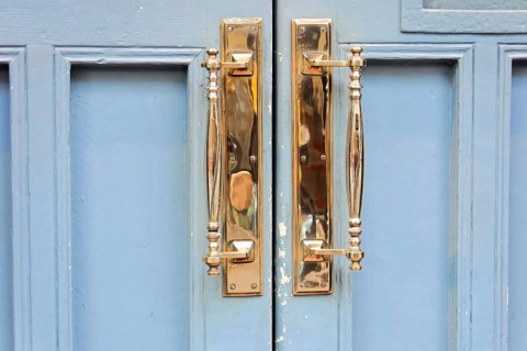London, England, Great Britain, Europe, Close-up of golden door handles on a blue door