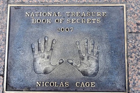 Nicolas Cage's handprints for National Treasure on a metal plate on the pavement, London, England,