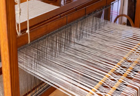 Closeup shot of a historic wooden loom with threads