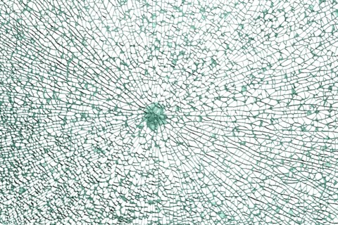 Full frame shot of a broken safety glass pane in white back