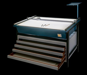 Illuminated layout table with open drawers isolated in black back