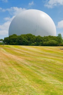 Gigantic white cupola with parabolic antenna inside, seen in Brittany, France