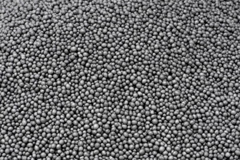 Full frame closeup showing lots of dark polystyrene beadlets