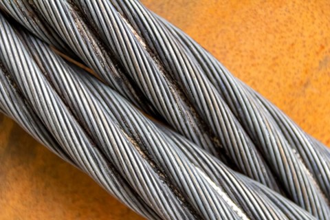 Closeup shot of wire ropes on rusty ground