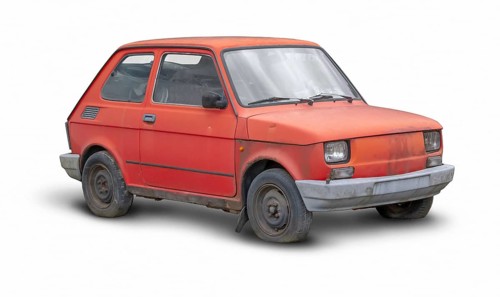 Small rundown red compact car in white back with shadow
