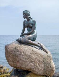 Bronze statue located in Copenhagen in Denmark named The Little Mermaid
