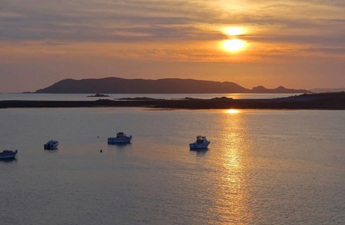 Idyllic sundown with some boats at the Pink Granite Coast in Brittany, France