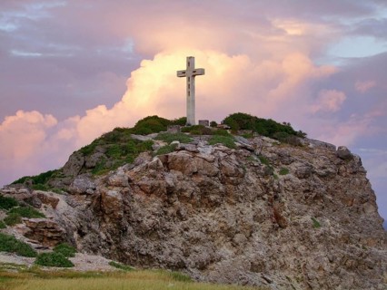 Colorful sundown scenery on a caribbean island named Guadeloupe including a summit cross on