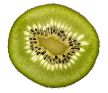 Thin translucent sliced kiwifruit in white back