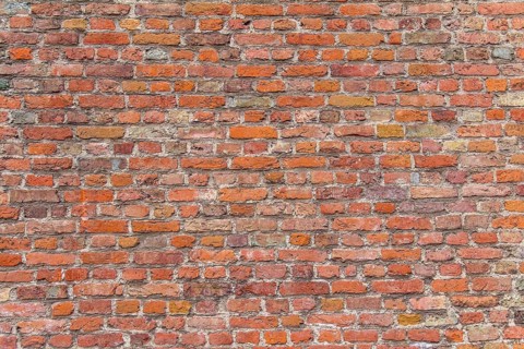 Full frame rundown red brick wall detail
