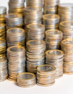 Lots of stacked 1 euro coins