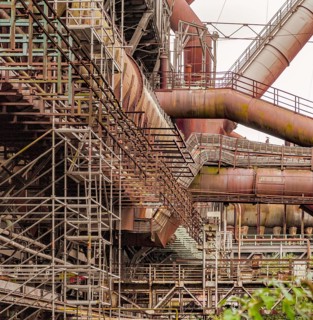 Weathered rusty industrial scenery with old corroded steel girders and metal tubes