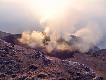Smoky crater scenery at Stromboli volcano near Sicily at evening time