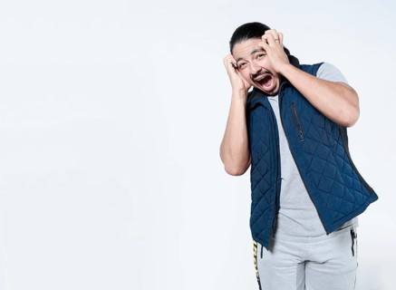 Horrified man with holding his face on isolated background