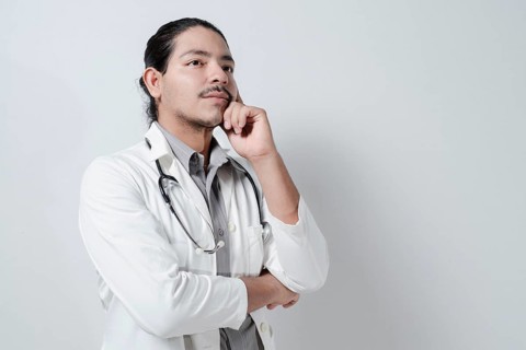 Friendly doctor hand on chin on isolated