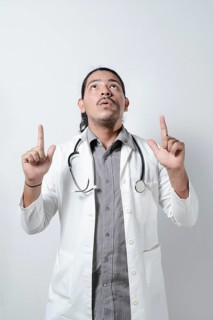 Shocked doctor looking up on isolated