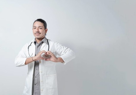 Young doctor heart hand in stethoscope