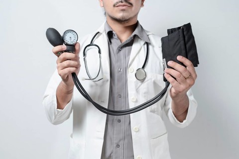 Doctor showing tensiometer on isolated