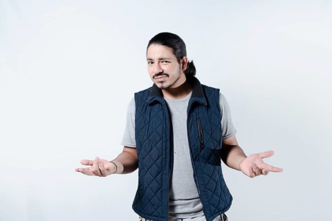 Confused young man with arms at his sides. Young male gesturing confusion on isolated background