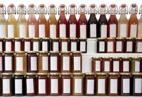 Lots of preserving glasses and bottles filled with colorful content