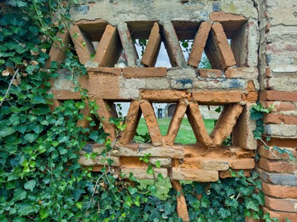 Brick wall with triangular cavities and ivy, lends a rustic flair Styria Austria