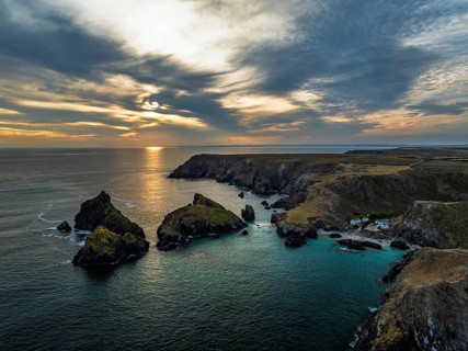 Sunset over Kynance Cove from a drone, Mount's Bay, Lizard Point, Cornwall, England, United Kingdom