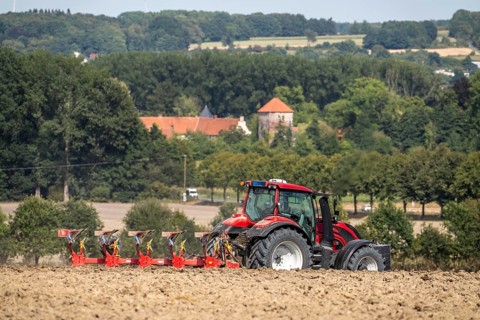 Tractor ploughs up a harvested grain field, south of Billerbeck in Münsterland, North