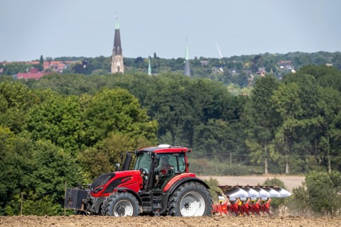 Tractor ploughs up a harvested grain field, south of Billerbeck in Münsterland, North