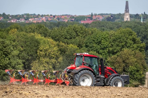 Tractor ploughs up a harvested grain field, south of Billerbeck in Münsterland, North