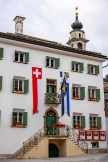Beautiful City Hall with Swiss and Canton Flag in a Summer Day in Samedan, Grisons, Switzerland